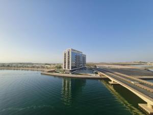 a tall building next to a body of water at Belstay2 in Ras al Khaimah
