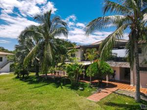 a house with palm trees in front of it at Amara Hotel in Doradal