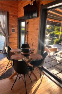 a dining room with a table and chairs and a patio at Paul Lake Escape Residence in Novosëlki