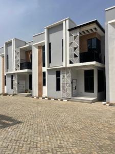 a building with balconies and a brick driveway at Luxury Four Bedroom Duplex in Asokoro Abuja in a Secure Estate with Fast WiFi & 24hours Electricity in Asokoro