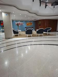 a lobby with chairs and a dance floor at Hotel Chacao Cumberland in Caracas +20 photos