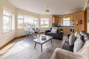a living room with a couch and a table at Hillside House - Rose Cottage in Ballinamuck