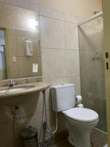 a bathroom with a toilet and a sink and a shower at Hotel orla House in Petrolina +17 photos