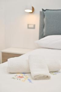 a bed with two towels on top of it at Lucia Appartamenti in Ischia Town
