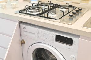 a stove top oven sitting on top of a washing machine at Lucia Appartamenti in Ischia Town
