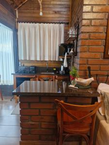 a kitchen with a counter and a sink in a room at Cabana Davos in Timbe do Sul