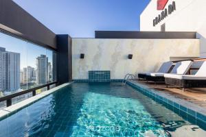 a swimming pool on the roof of a building at Apt w/ BBQ and Partial Ocean View ALE0803 in Piçarras