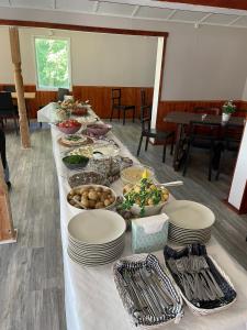 a long table with plates of food on it at Sikhall Camping & Restaurang in Sörbo
