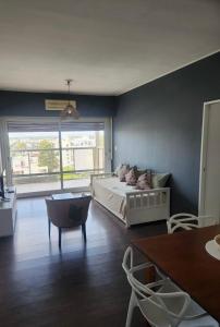 a bedroom with a bed and a large window at Apart Rucapel in General Roca