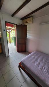 a bedroom with a bed and a door to a bathroom at Bellevue Studios in Mare Gaillard