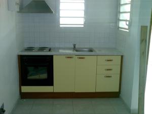 a kitchen with a sink and a stove at Bellevue Studios in Mare Gaillard