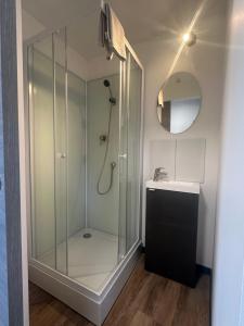 a glass shower in a bathroom with a sink at California in Maretz