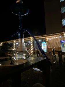 a lamp sitting on a table at night at Barakat Hotel in Ureki