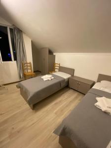 a room with two beds and chairs in it at Barakat Hotel in Ureki