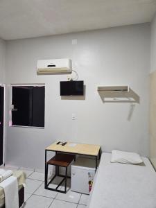 a room with two beds and a desk in it at Canto da Duna Hotel in Barreirinhas