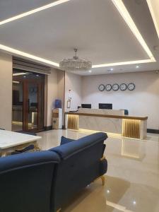 a living room with a couch and a table at Volidam Hotel in Qarshi