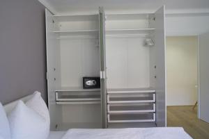 a bedroom with a bed and a glass closet at Modernes Apartment in Schwechat in Schwechat