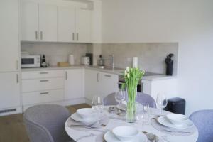 a dining room table with plates and wine glasses at Modernes Apartment in Schwechat in Schwechat +18 photos