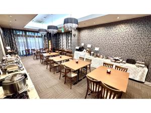a dining room with tables and chairs in a restaurant at Royal Hotel Uohachi - Vacation STAY 71045v in Toyota