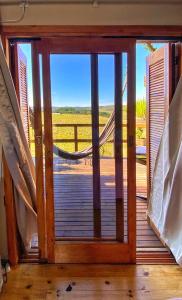 a door to a porch with a view of the ocean at Vale de Cambara in Cambará +5 photos