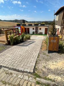 a brick driveway in front of a house at Vale de Cambara in Cambará