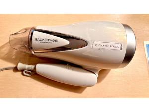 a hair dryer sitting on top of a table at Royal Hotel Uohachi - Vacation STAY 71048v in Toyota