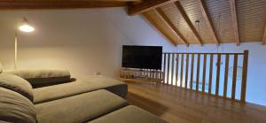 a living room with a couch and a flat screen tv at Casa da Picoteira - Pool - Pets - EV Charger in Proença-a-Nova