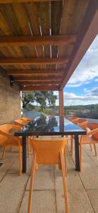 a black table and chairs on a roof at Casa da Picoteira - Pool - Pets - EV Charger in Proença-a-Nova