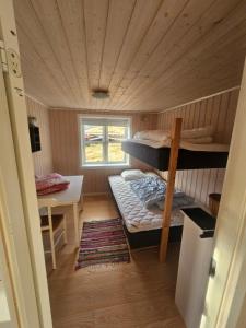 a small room with a bunk bed and a desk at Mulheidar in Leynar