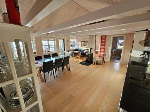 a kitchen and living room with a table and chairs at Mulheidar in Leynar