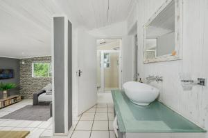 a bathroom with a sink on a glass counter at 302 On Old Sea View Road Chelsea in Port Elizabeth +100 photos