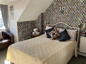 a bedroom with a bed in a room with a wall at The Sunningdale in Skegness