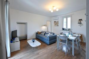 a living room with a couch and a table at Lora Luxury Suite 6 ,free private parking, self check in, air conditioner in Como