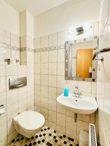 a bathroom with a toilet and a sink at Hotel am Freihafen in Duisburg +79 photos