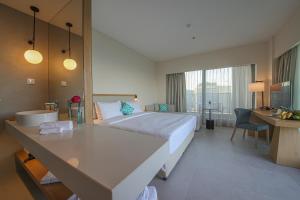 a hotel room with a bed and a desk at Poseidon Beach Resort - Premium All Inclusive & Free Riviera Beach Access in Golden Sands