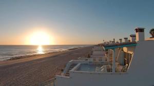 a view of the beach at sunset at Cozy & Colorful Beachfront Condo Las Olas I 28 in Puerto Peñasco
