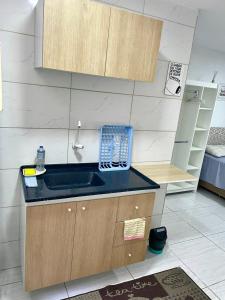 a kitchen with a sink and a telephone on a counter at Studio 107 in São Paulo +55 photos