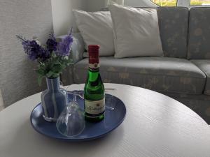 a bottle of wine and a glass on a table at Charmanter Bungalow in Neubukow nahe der Ostsee in Neubukow