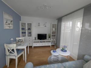 a living room with a couch and a table at Charmanter Bungalow in Neubukow nahe der Ostsee in Neubukow