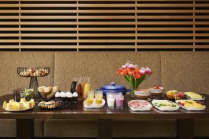 a table with breakfast foods and drinks on it at NH Ludwigsburg in Ludwigsburg +16 photos