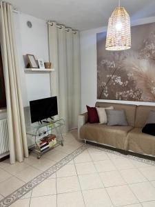 a living room with a couch and a tv at Iris in Montecchio Maggiore