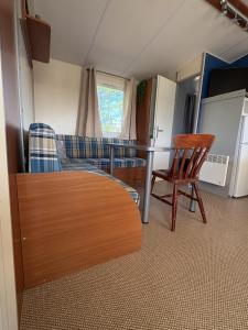 a living room with a couch and a table and chairs at camping de la mottelette in Forest-Montiers +92 photos