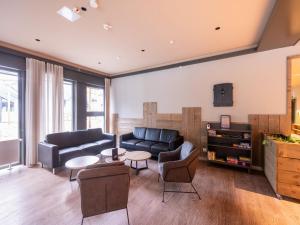 a living room with a couch and a table at Hambachtal forest hideaway boutique resort in Oberhambach