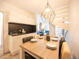 a kitchen and dining room with a table and chairs at Hambachtal forest hideaway boutique resort in Oberhambach