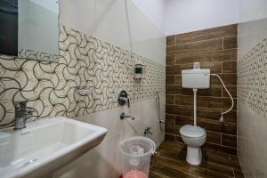 a bathroom with a sink and a toilet at Laxman Avenue in Jagdalpur