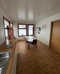 a kitchen with a table and a dining room at Guesthouse Myrkholt II in Tungufell +9 photos