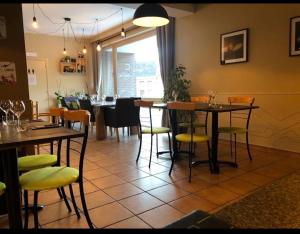 a dining room with tables and chairs in a restaurant at Les Remparts in Antoing