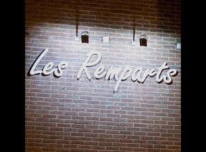 a brick wall with a sign that says le rentals at Les Remparts in Antoing