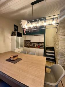 a kitchen with a table and chairs and a staircase at Chalet de la fée Marion et Alice in Virton +7 photos