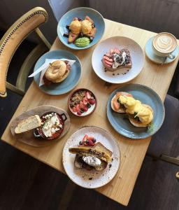 a wooden table with plates of food on it at The Bugle Coaching Inn in Yarmouth